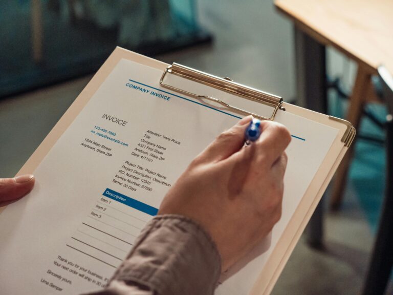 Person hand holding commercial collections debt collection paper.